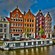 Buildings and houseboats lining a canal in Amsterdam, the Netherlands 