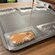Melted milk chocolate being poured into a mold on a baking sheet