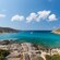 A sailboat anchored in a cove along the Rhodes coastline