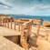 Ancient stone columns standing at the bottom of steps   
