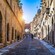 A cobblestone street lined with stone buildings in Rhodes Old Town