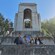A boy and a girl posing next to their parents in front of a structure at the Wrigley Memorial and Botanic Garden on Santa Catalina Island, California