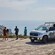 Three Guests and a guide standing on a cliffside overlooking the ocean near an open air tour truck with the words, ‘Catalina Island Conservancy Eco Tour’