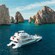 Aerial view of a luxury catamaran anchored near the iconic El Arco in Cabo San Lucas