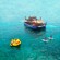 Aerial view of Guests paddleboarding and floating on a giant inflatable duck near BLU Floating Ocean Club