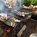 Multiple people grilling fresh fish on a large outdoor grill