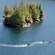 Two people speeding across the waters of Ketchikan, Alaska in a motor raft