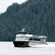 A double decker tour boat cruising through the waters around Ketchikan, Alaska