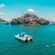 A catamaran with several passengers and a few Guests swimming, near an islet in Mazatlan, Mexico