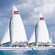 2 catamarans filled with passengers gliding through the water