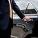 A driver opening the door of a private sedan