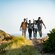 Four people hiking on a trail to Harbors Edge on Catalina Island