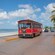 An old fashioned trolley car parked on an oceanfront street