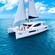 A catamaran sails on a calm ocean