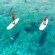 People standing up on paddleboards in the ocean in Cozumel, Mexico