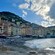 People relaxing on Spiaggia di Camogli near picturesque buildings along the shore