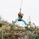 A man zip lining over a cliff in Maui, Hawaii