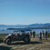 A group of people standing next to a UTV with Behm Canal in the distance