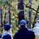 Two people admiring a waterfall in an Alaskan forest