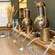 A bar station with a built in sink and 3 copper gin distillers lined against the wall