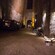 A dark tunnel with dirt, cars and a bike in the Galleria Borbonica in Naples, Italy