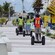 Un grupo de personas en Segway recorriendo una amplia acera en Progreso
