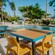 A dining table and three chairs next to a pool