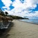 A beach with umbrellas and chairs in Roseau, Dominica