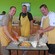 Three men preparing a meal in a kitchen in Roseau, Dominica