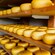 Rows of cheese wheels on shelves