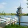 A windmill on the banks of a canal located in Kinderdijk, Holland