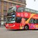 A double decker tour bus with the words ‘City Sightseeing Amsterdam’ 