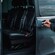 A private driver opening the door of a luxury van