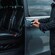 A private driver opening the door of a luxury van