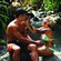 A man and a woman playfully smearing each other with mud