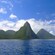 Steep, tree covered mountains next to the ocean