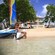 A woman sitting on a small catamaran at the shore of Reduit Beach in Saint Lucia