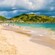 The shoreline of Orient Bay Beach on Saint Maarten with mountains in the background