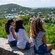 Tres mujeres sentadas en una cornisa con vistas a San Juan, Islas Vírgenes de Estados Unidos