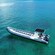 A long, multi passenger power boat on the water