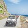 Four off road vehicles driving along the shore of Tortola