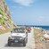 Four off road vehicles driving along the shore of Tortola