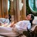 Two women relaxing on cushioned lounge chairs inside a spa