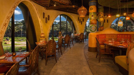 Dining room tables by windows overlooking the savanna at Sanaa restaurant