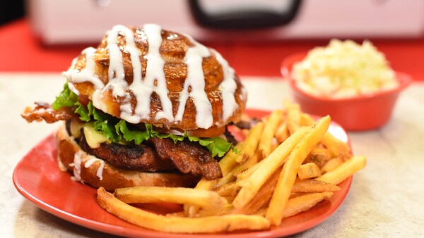 A cinnamon bun cheeseburger and fries on a plate