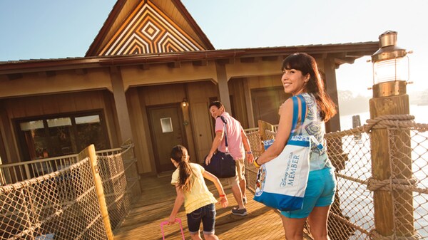 A family carrying bags to a Bungalow at Disney's Polynesian Villas & Bungalows