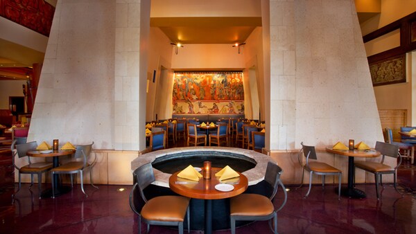 Interior of the majestic Maya Grill restaurant, with many tables and chairs