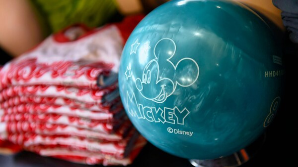 A bowling ball decorated with a Mickey Mouse head