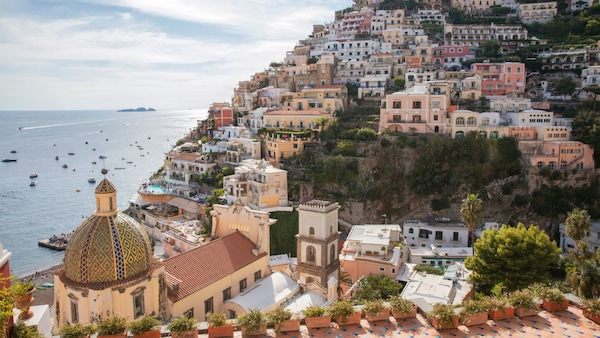 The Amalfi Coast at Positano, Italy, with many structures along the coastline and hillside 