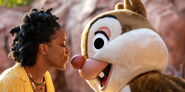 A woman kisses Dale, the chipmunk, on his nose
